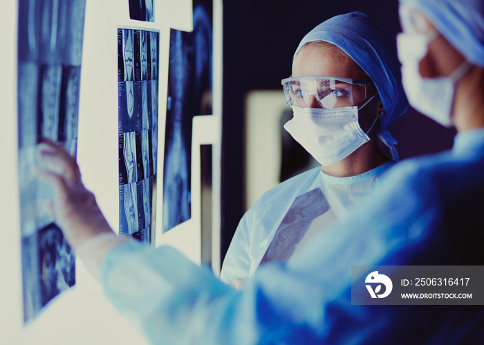 Two female women medical doctors looking at x-rays in a hospital