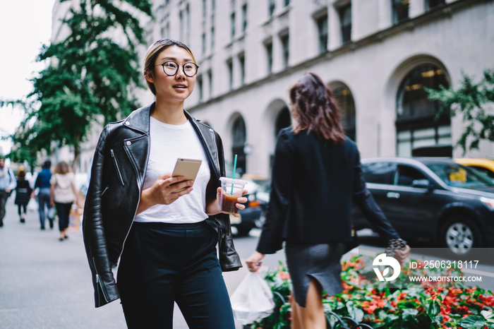 拥有移动技术的魅力女博主在城市空闲时间走在街上，b