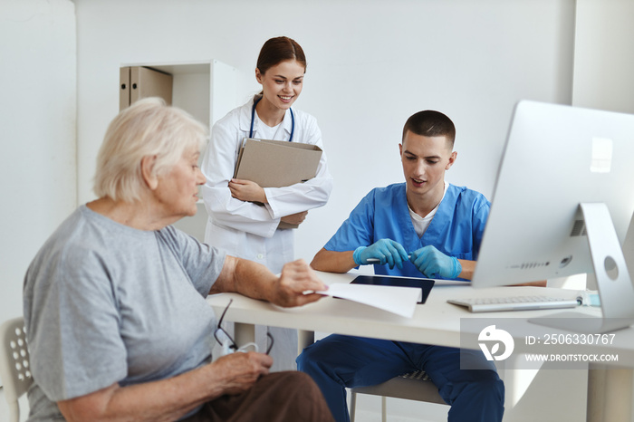 a nurse and a doctor examining a patient hospital professional consultation