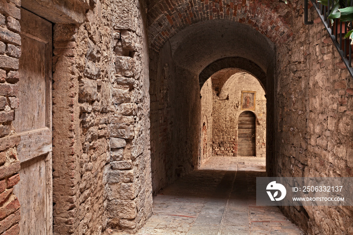 Todi, Umbria, Italy: ancient narrow alley with underpass in the old town