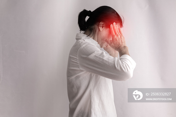 asian elderly woman having headache on isolated white background.