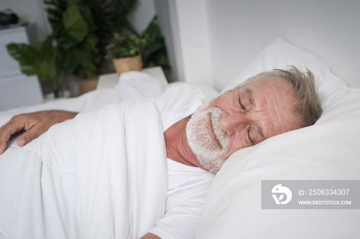 senior man sleeping alone and headache or dreaming nightmare on bed in room