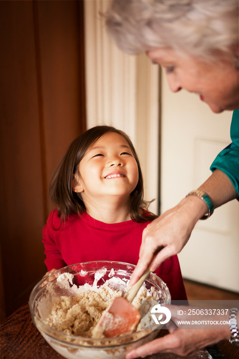 Grandmother baking with granddaughter (4-5)