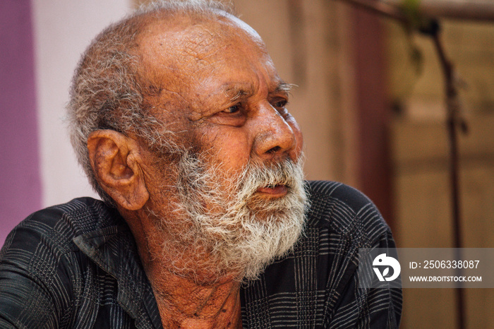 Portrait of an old Indian man looking sideways