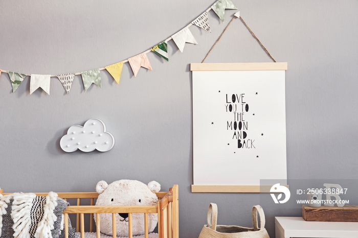 Stylish and cute scandinavian decor of  newborn baby room with mock up poster, natural toys, hanging