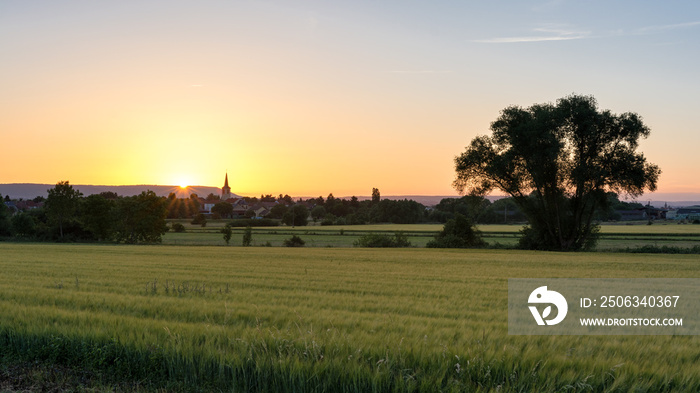 French countryside - Lorraine. A small village with church surrounded by wheat fields with hills in 