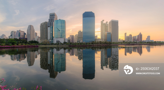 high modern building city nearby the park in central city at morning with water reflection.