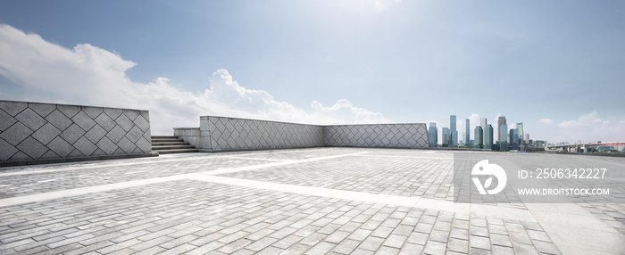 empty floor and modern city in sunny sky