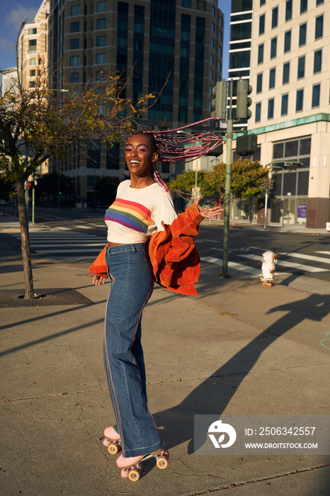  Portrait of young non-conforming with braids on rollerskates in city