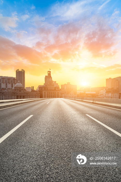 Shanghai bund city skyline and empty asphalt highway at sunset