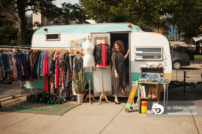 Vintage store owner creating display outside