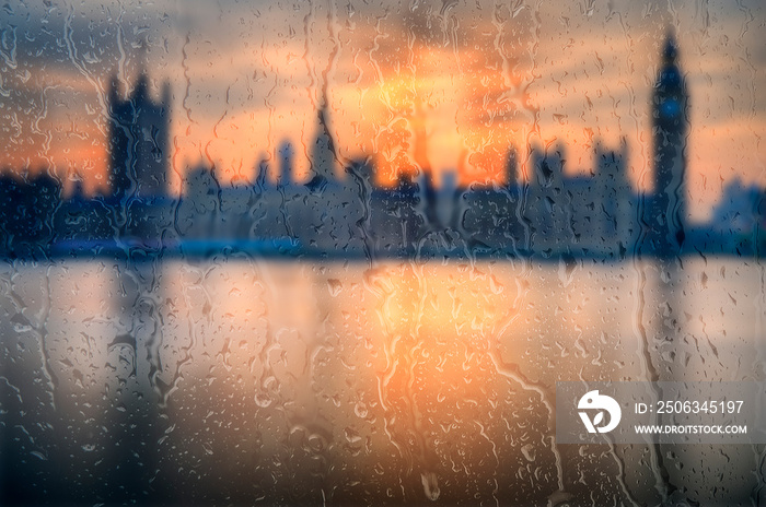 Beautiful landscape concept view of London City through glass window with streaks of rain and raindr