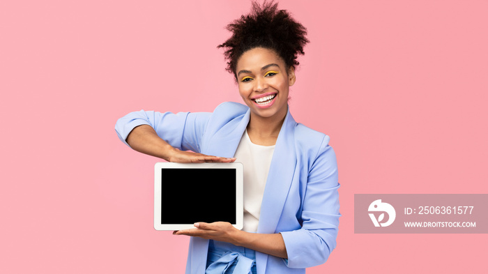 Happy black woman showing black blank computer screen