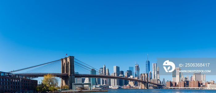 Wide panorama of skyscrapers in Manhattan with Brooklyn Bridge, New York at daytime