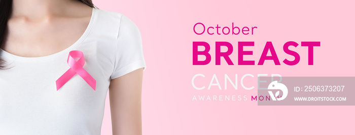 Woman in white t-shirt with pink ribbon supporting breast cancer awareness campaign