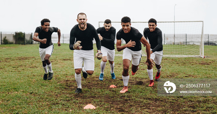 Football players celebrating victory running on field