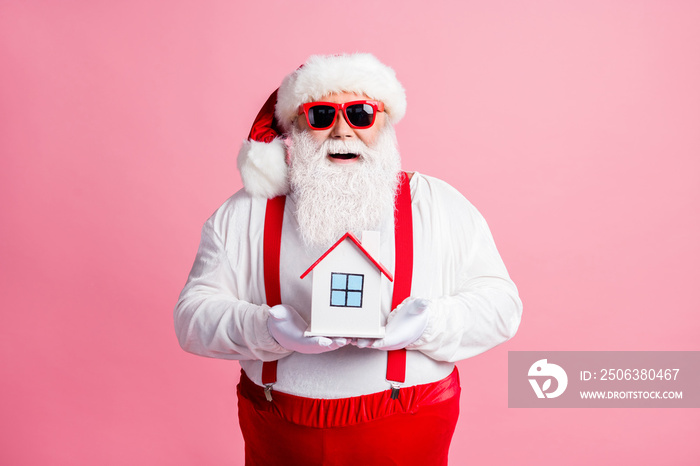 Portrait of his he nice attractive cheerful cheery Santa father holding in hands house comfort life 