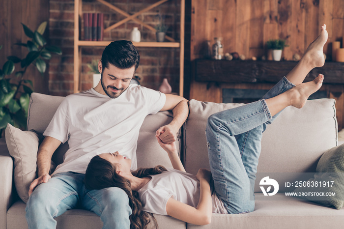 Portrait of attractive cheerful couple soulmates sitting on divan enjoying having fun talking at lof