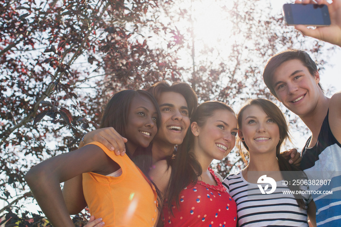 Five teenagers taking self portrait with smart phone