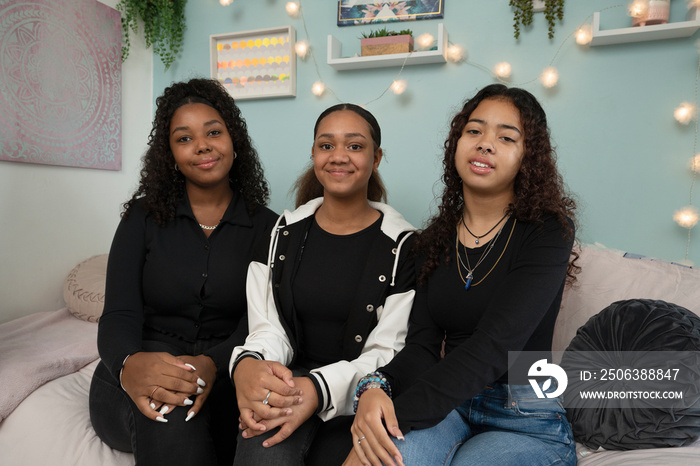 Portrait of smiling girls in bedroom