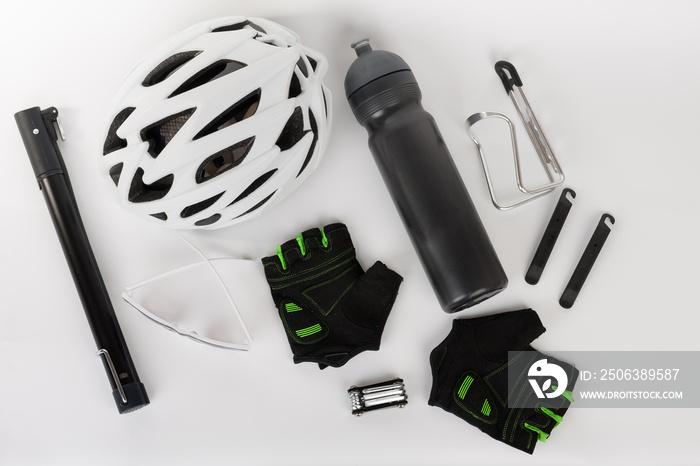 Bike accessories, bike helmet, bike gloves, eyeglasses and water bottle in holder