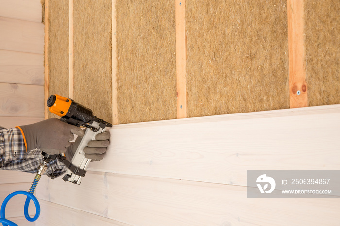 Construction worker thermally insulating eco wooden frame house