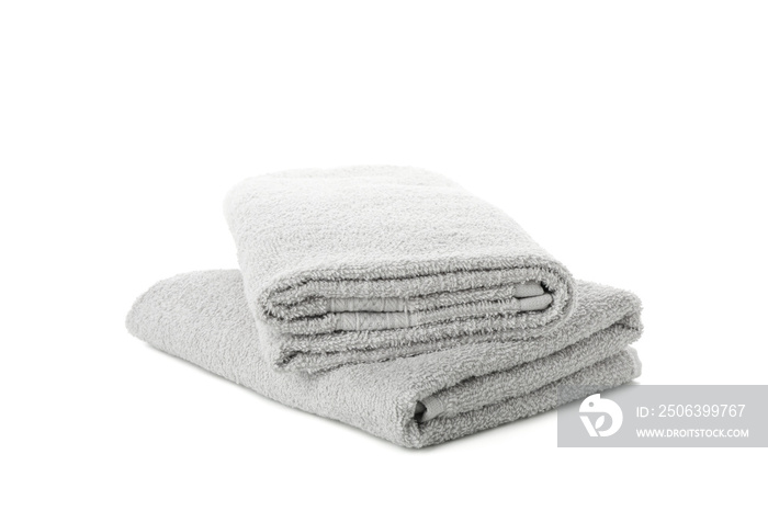 Folded grey towels isolated on white background, close upFolded grey towels isolated on white backgr