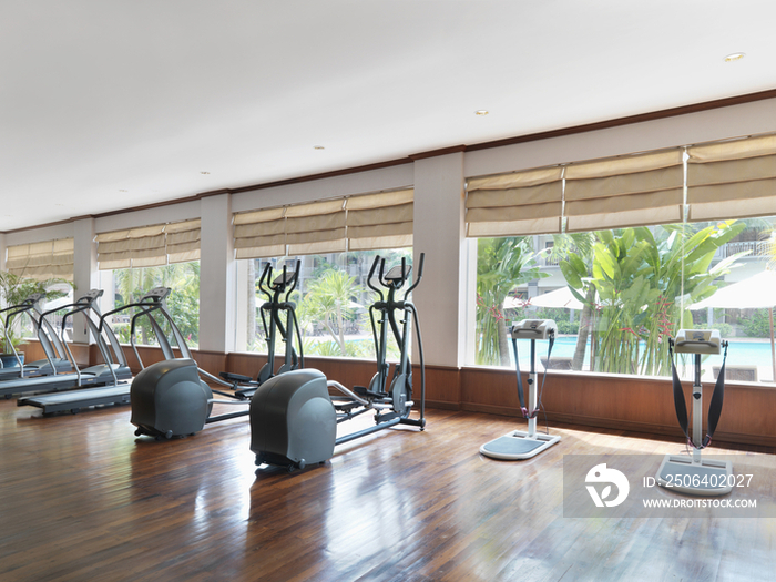 Treadmills in spacious health club of hotel