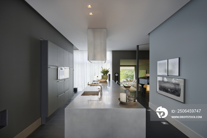 Modern kitchen with living room in the background