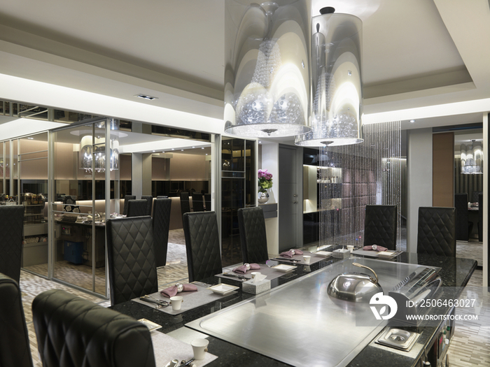 Chandeliers above elegant dining table in hotel restaurant