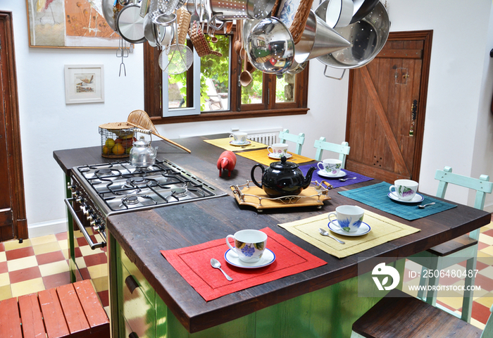 Tea cups and kettle on breakfast bar