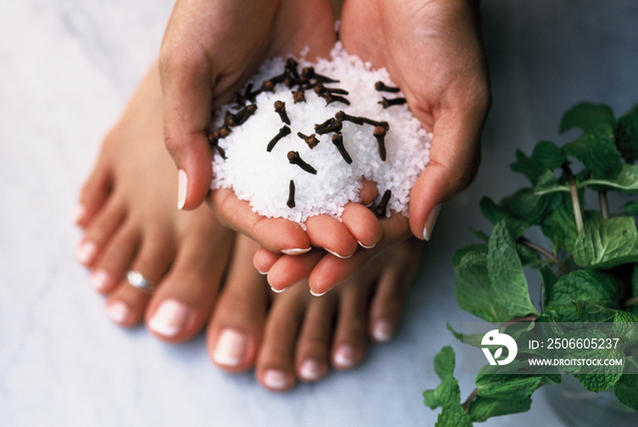 Woman with handful of salt and cloves