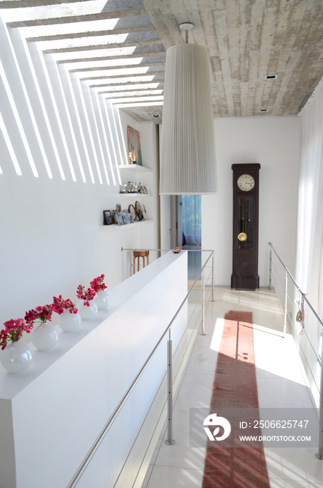 Steps and pendant light hanging from ceiling in middle class home