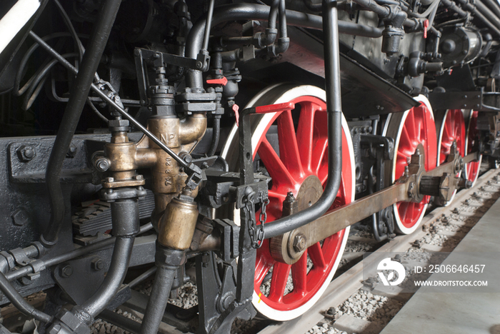 Close up of the rows of steel wheels of a locomotive train