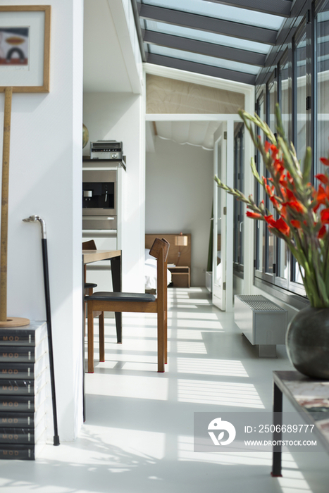 Dining table and bedroom along the hallway at modern house