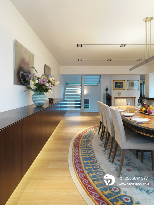 Chairs around cropped set table in a spacious and contemporary dining room; Scottsdale; USA