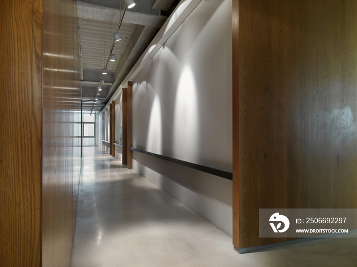 Picture frames on shelf at empty hallway in office