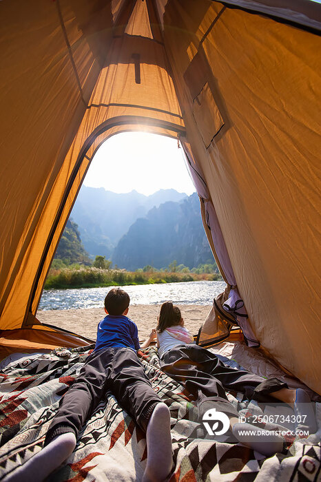 可爱的兄妹俩在帐篷里欣赏周围的自然美景
