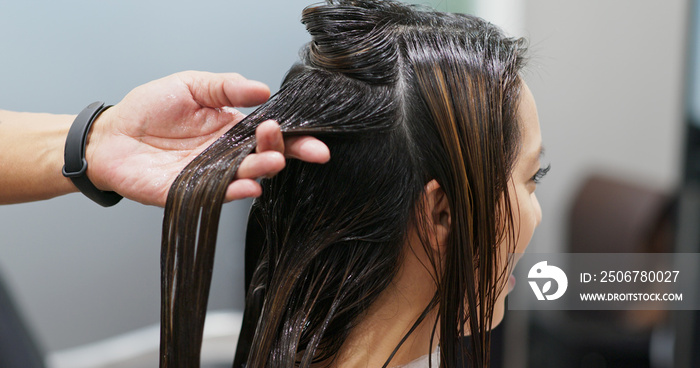 Woman having hair treatment in hair salon