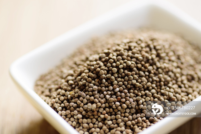 Close up of organic perilla seeds in a bowl, healthy herbal seed ingredient in Asian food