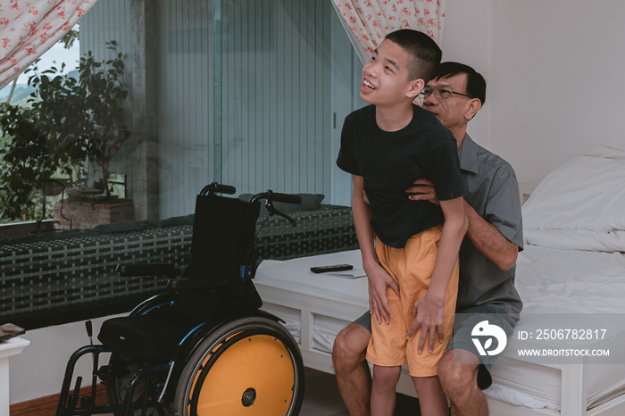 Asian disabled child standing practice with father and wheelchair in the bed room, Lifestyle of disa