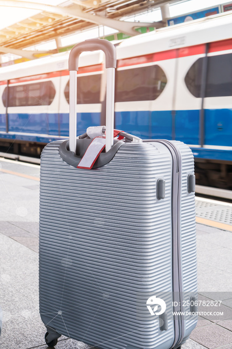 Sillver Suitcases or baggage at blurred of sky train station platform with network line for connecte