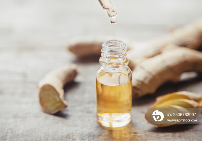 Ginger essential oil in a small bottle. Selective focus.