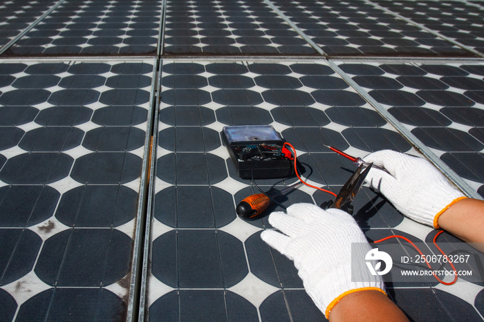 Technician repairing photovoltaic modules (Solar panels) in rural