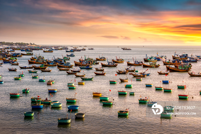 Traditional Vietnamese boat in the basket shaped on fishing port at Fishing village in sunset sky , 