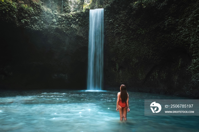 巴厘岛热带雨林旅行的年轻女子在美丽的蒂布马纳瀑布享受生活