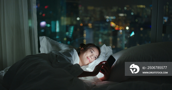 Woman use of mobile phone and read on cellphone at night