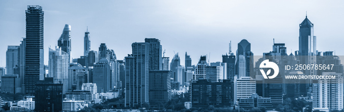 Blue-filtered cityscape and high-rise buildings in metropolis city center . Downtown business distri