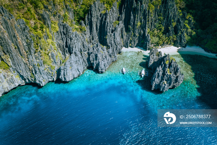 El Nido, Palawan, Philippines. Aerial above view of banca boats surrounded by karst scenery rocks at