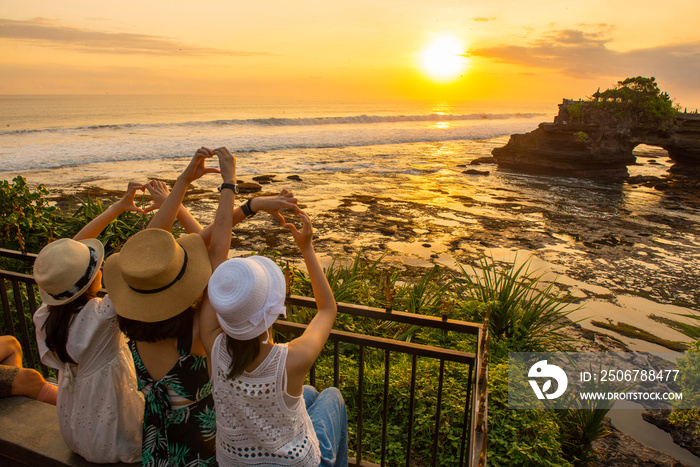 Happiness tourist enjoy their holiday with the beautiful sunset over Pura Batu Bolong an iconic Hind